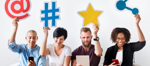 Practical strategies for online reputation management in social networks - people sitting on a white couch holding in their hands social media icons